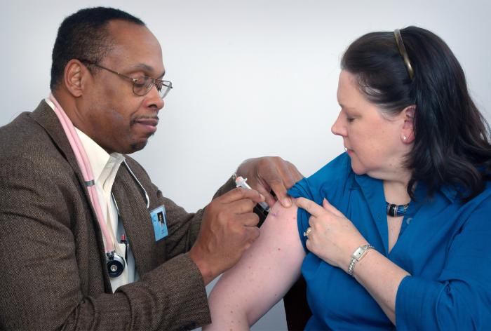 image of a doctor vaccinating a patient